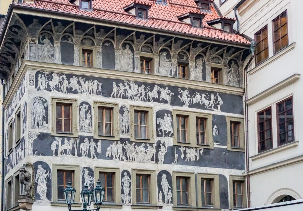 Prague architecture - gray and white mythical figures painting on a renaissance building facade in Prague