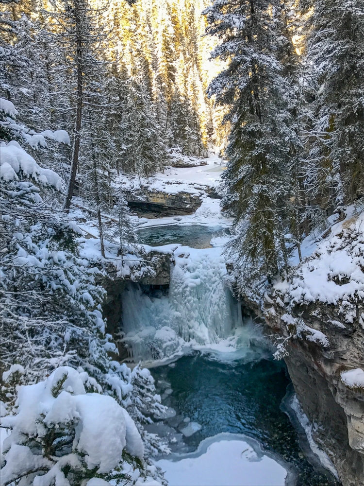 Banff National Park Johnston Canyon frozen waterfall in winter in snowy forest