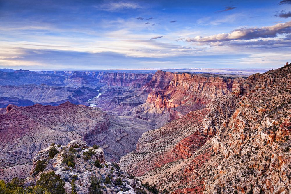 Sunset over the Grand Canyon, Arizona, USA. The Colorado River winds its way through the canyon it has created. This beautiful view can be seen from Navajo Point.