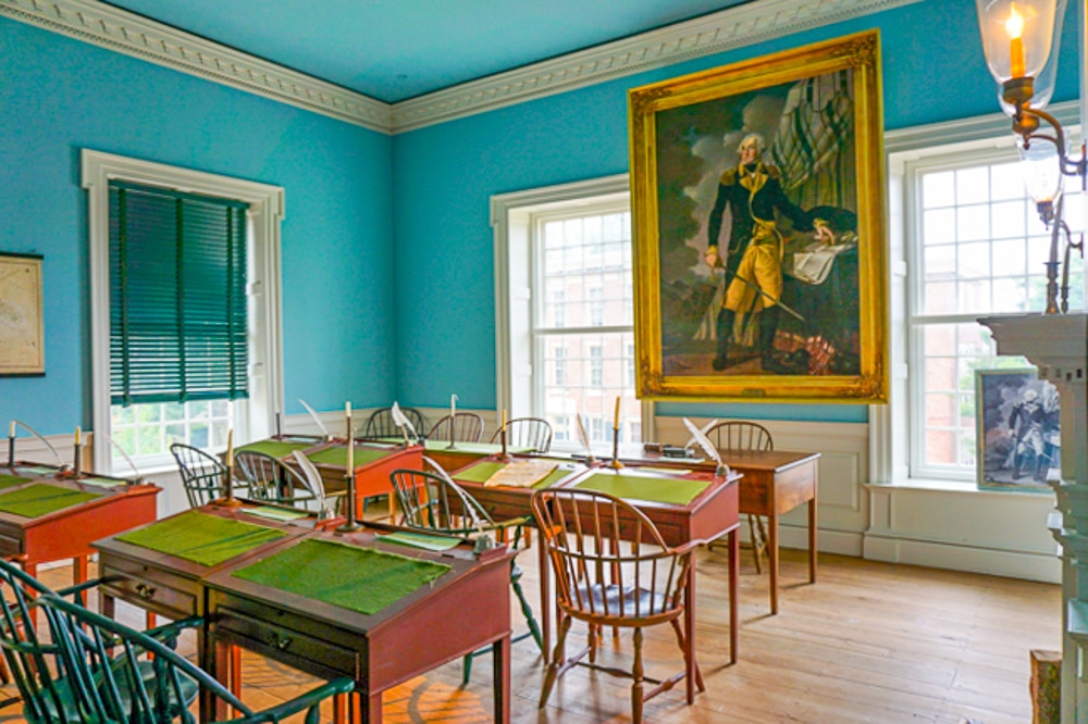 Old State House room with colonial style desks and chairs - one of the best things to do in Dover!