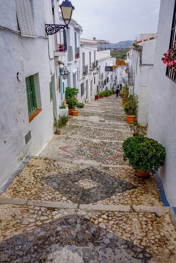 Mosaic staircase in Frigiliana Spain with white houses on either side