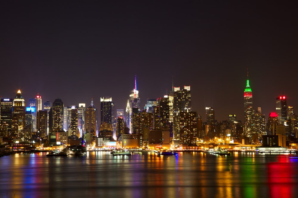New York City midtown skyline at night over Hudson river with refelctions viewed from New Jersey