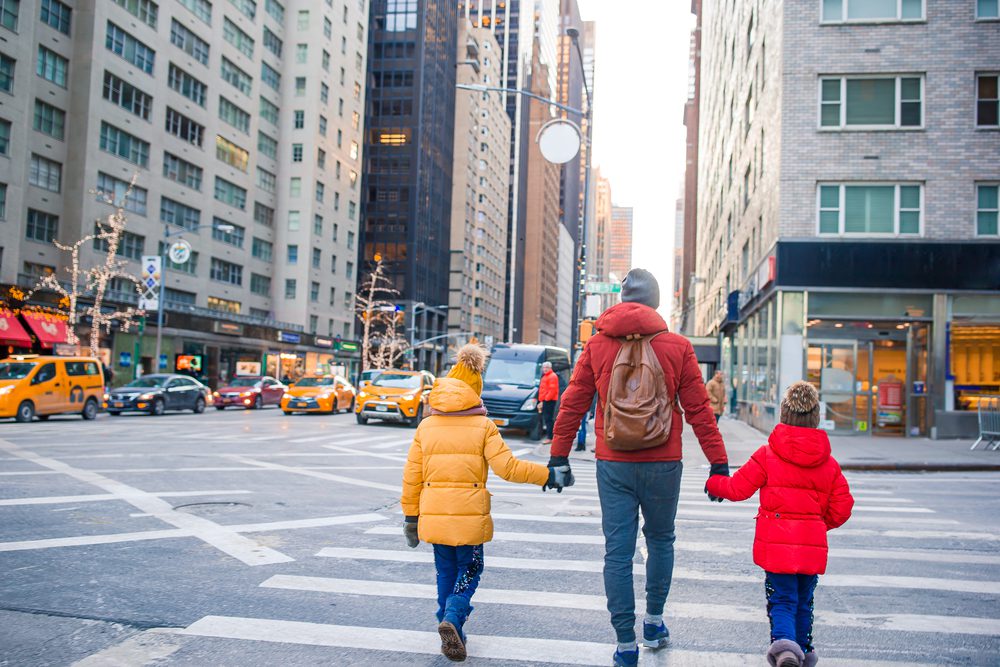 Family of father and his little kids walk on Manhattan in New York City