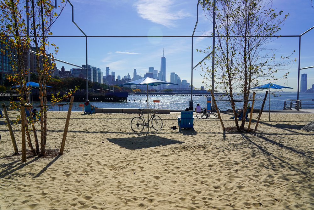 Gansevoort Penisula beach in Manhattan Chelsea NYC One World Trade Center in the distance