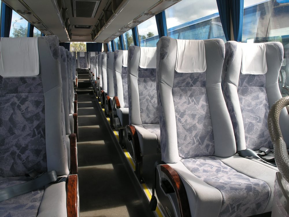 Inside of a bus with a close up of the seats