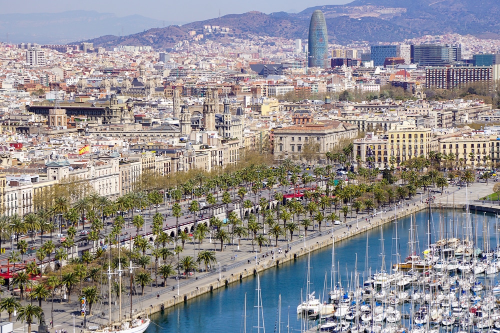 View overlooking Barcelona Spain with the harbor and boats in the foreground and the city in the background
