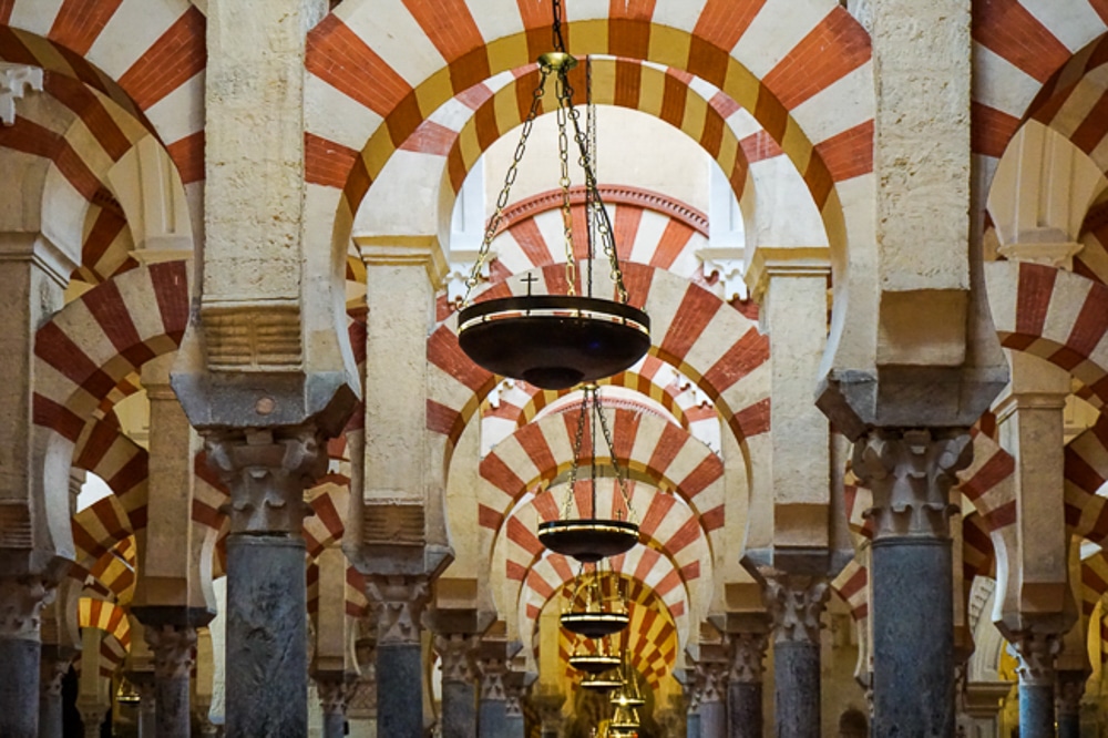 close up of the red and white arches at the Mosque Catherdal in Cordoba Spain