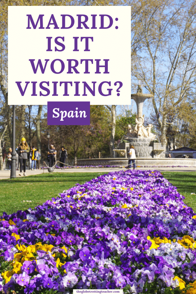 Is Madrid Worth Visiting Pinterest Pin with a photo of Retiro Park with purple flowers and text overlay