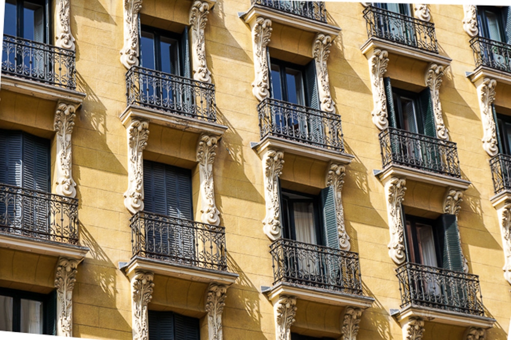 close up of a yellow building in Madrid Spain with ornate architecture