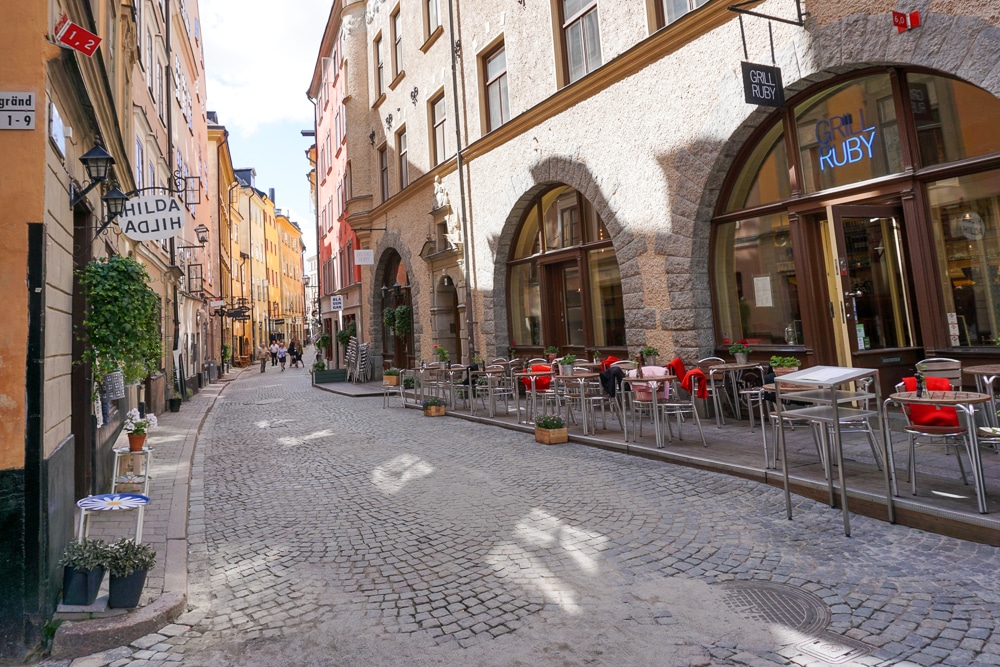Cobblestone street in Stockholm's Old Town with shops and restaurants on both sides