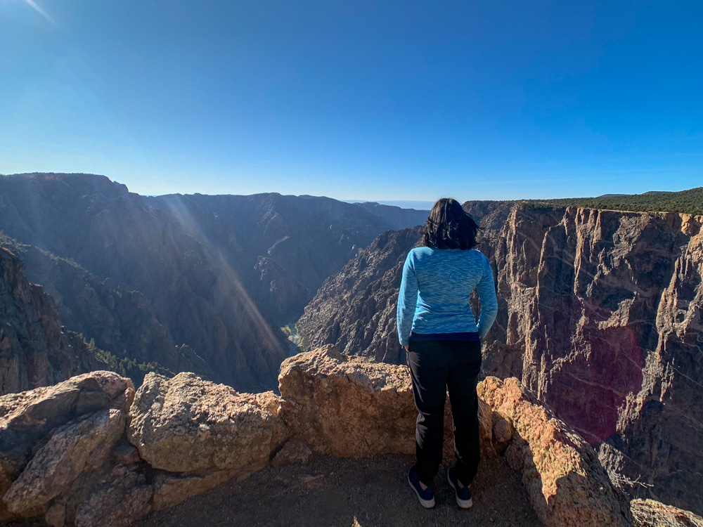 me overlooking the rocky cliffs at Black Canyon of the Gunnison National Park in Colorado