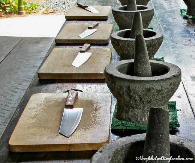 mortar and pestle stations with cutting boards and knives in front of each one