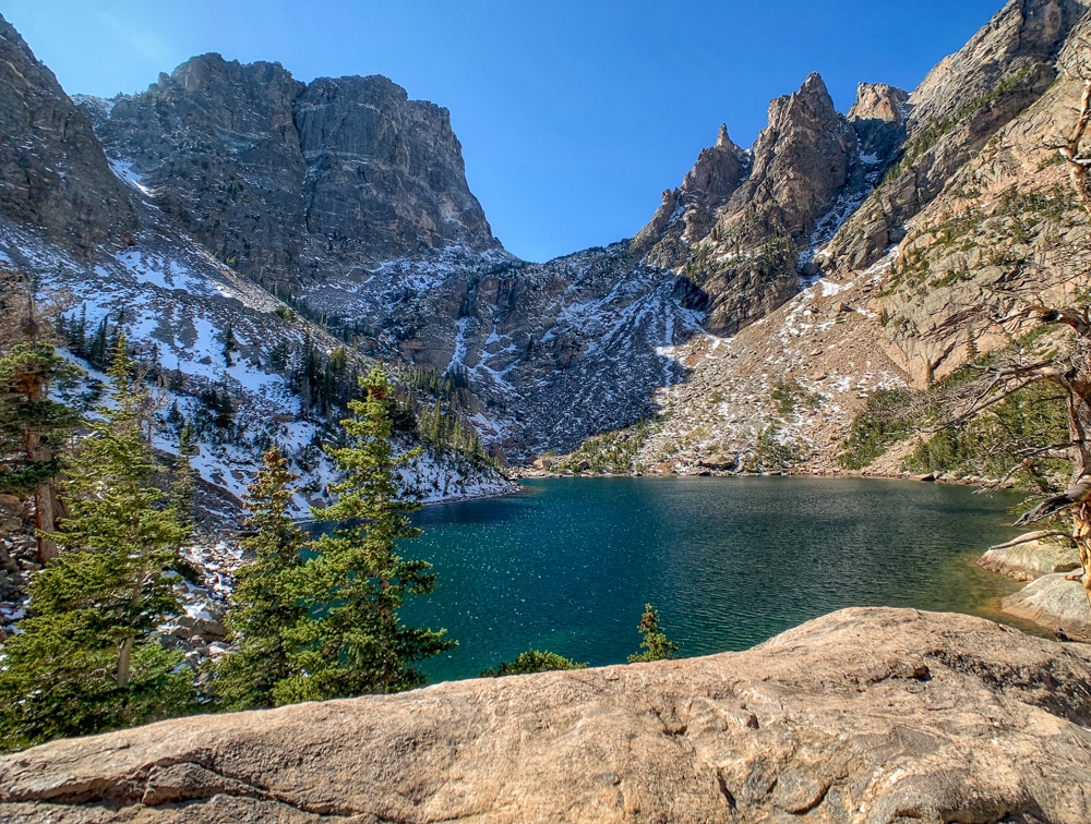 turquoise waters of emerald lake in Rocky Mountain National Park in Estes Park Colorado with mountains all around