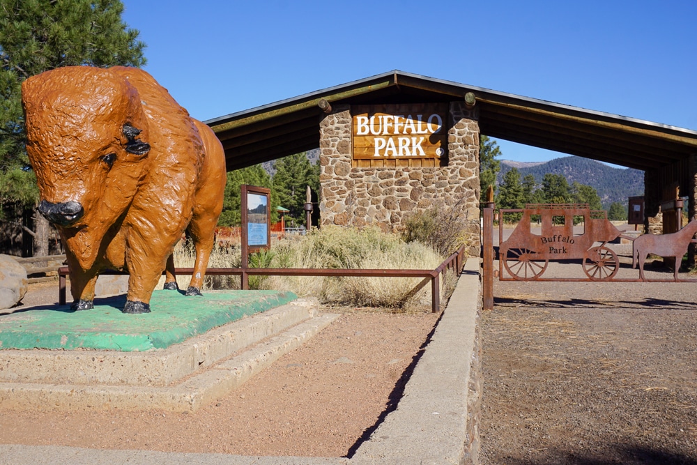 Buffalo Park entrance in Flagstaff with a statue of a buffalo and brick structure in the background