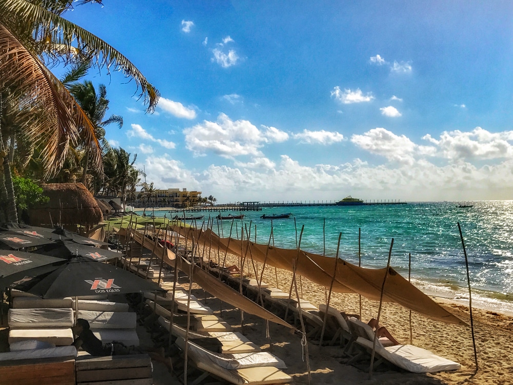 Beach club in Playa del Carmen Mexico with lounge chairs along the beach