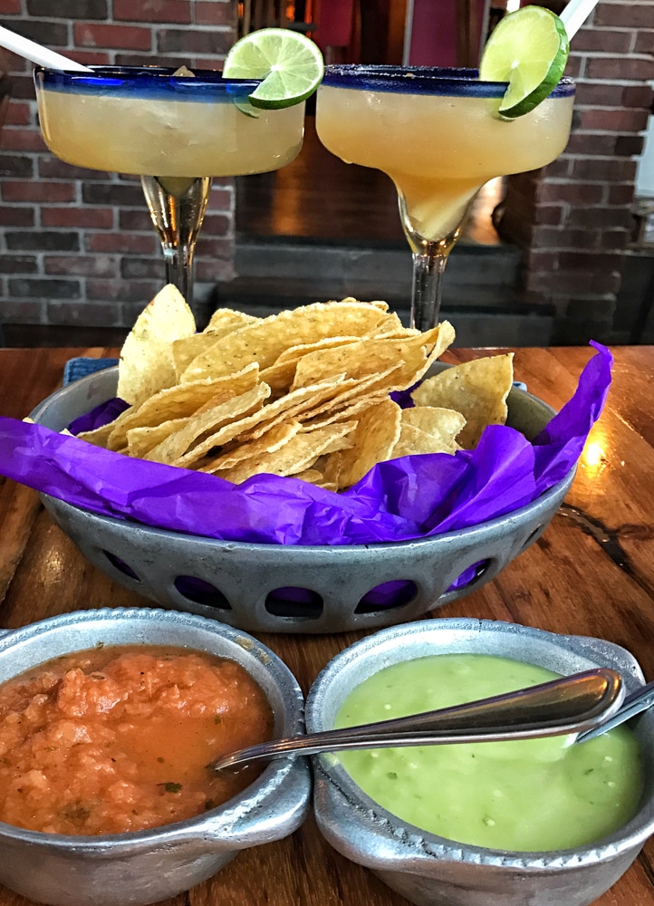 close up of chips salsa and guacamole with 2 margaritas in Playa del Carmen Mexico