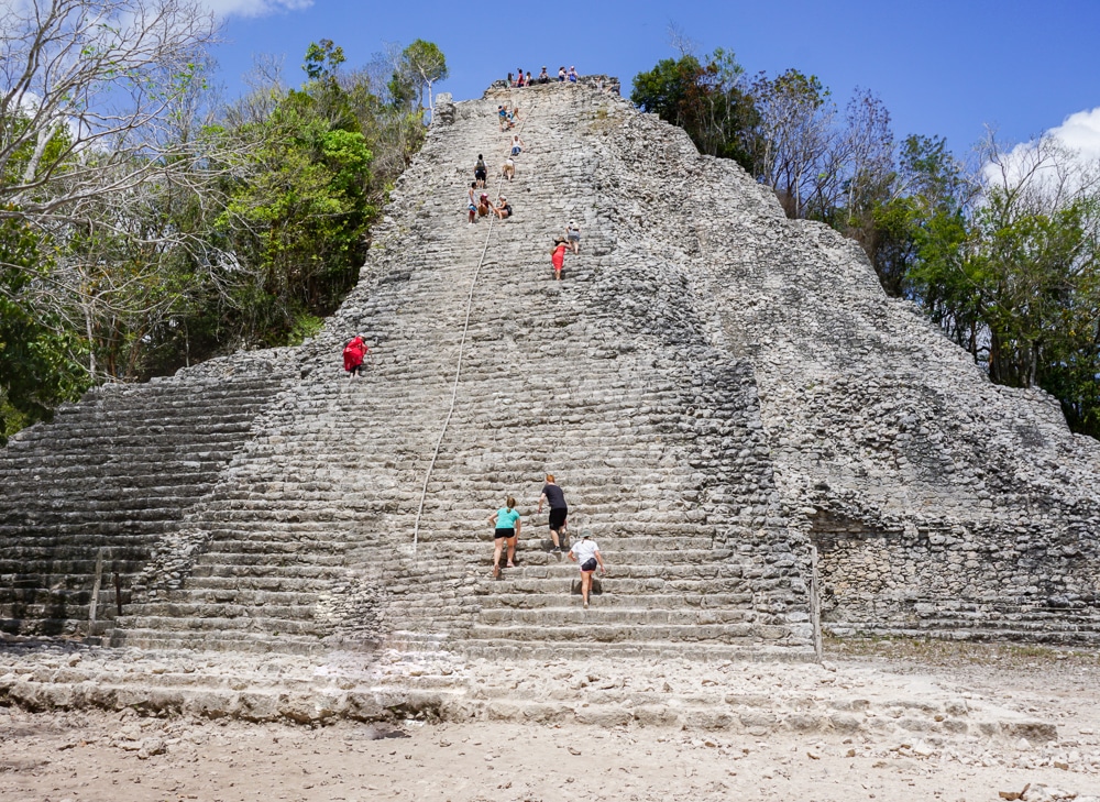 Coba Mayan ruins near Playa del Carmen and Tulum Mexico with people climbing to the top of the temple