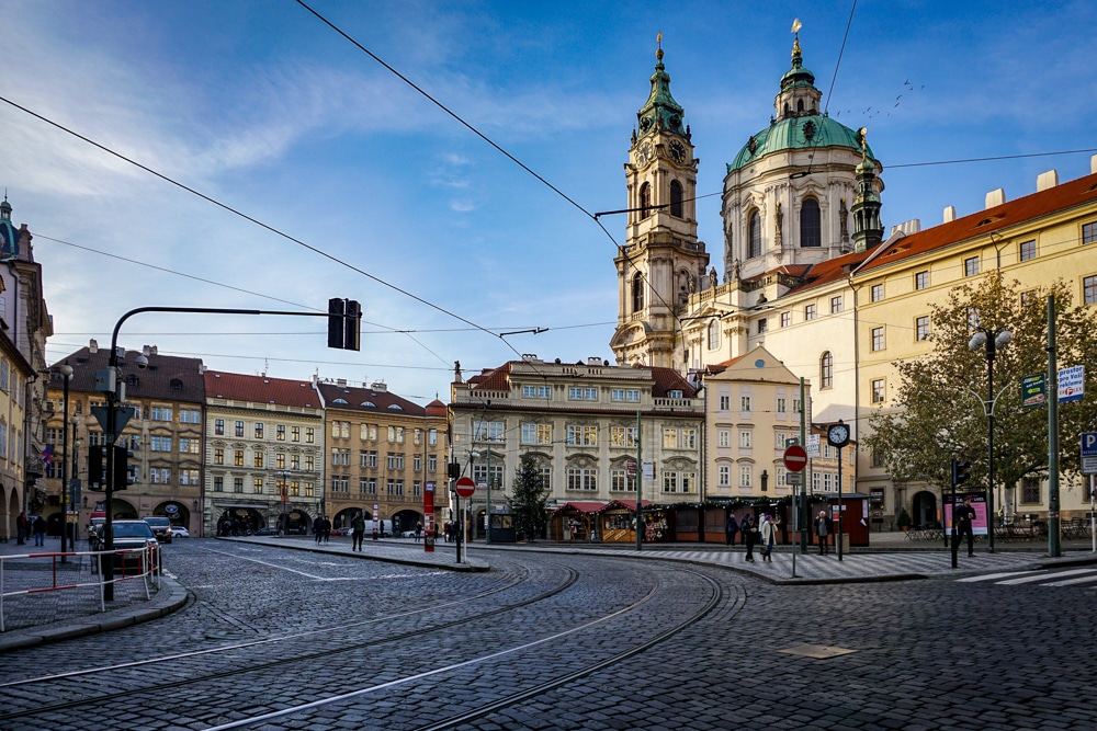 Prague architecture mala strana - domed building with street car tracks and cables