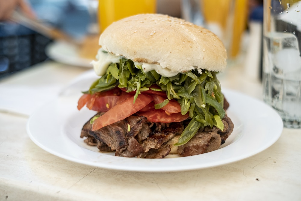 Famous Chilean chacarero sandwich, filled with steak, tomatoes, green beans, and mayonnaise.  Typical lunch dish in Chile.