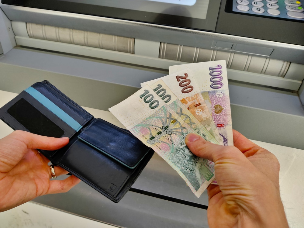 women taking foreign currency from an ATM