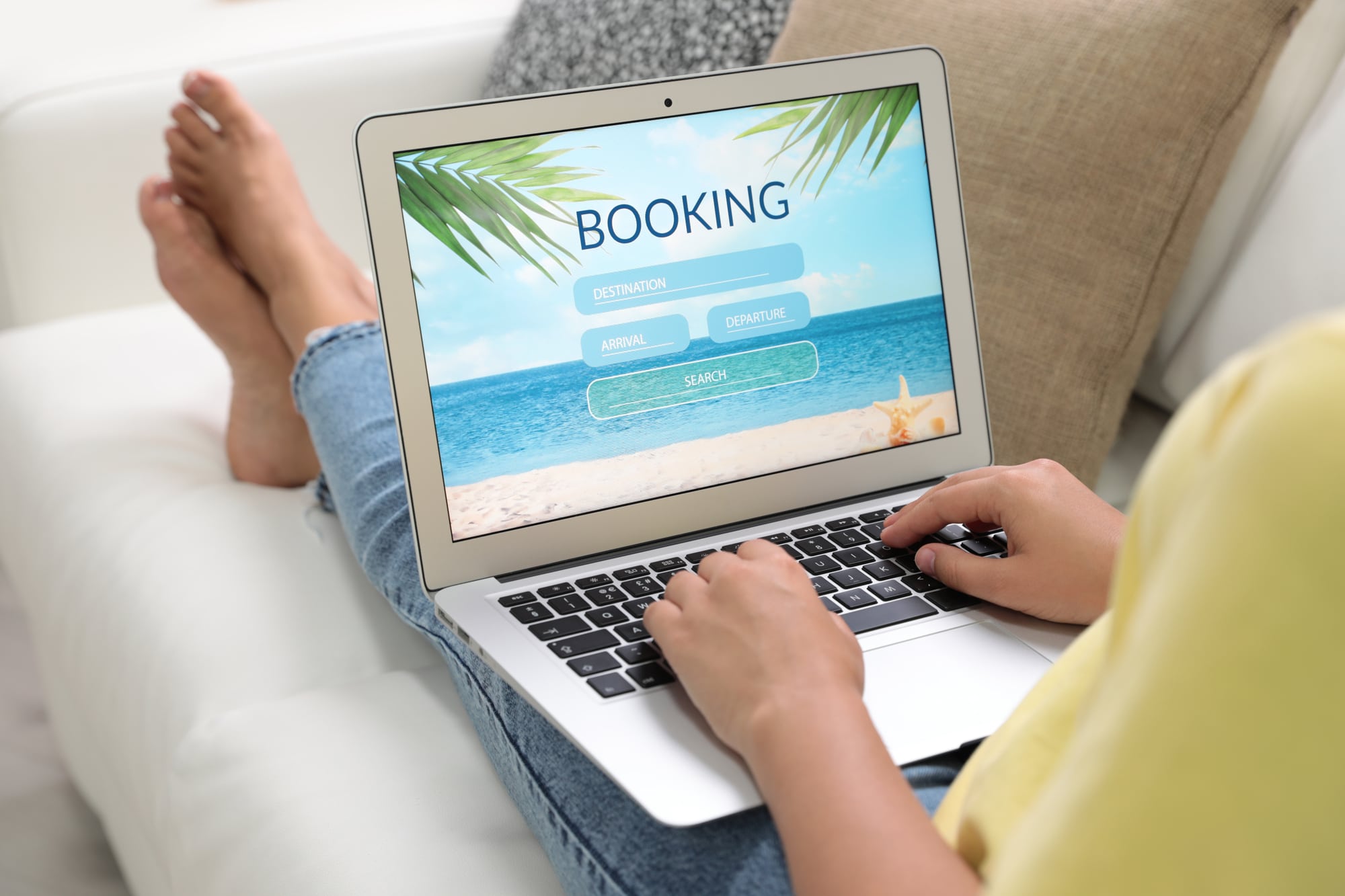 Woman booking hotel online indoors, closeup.